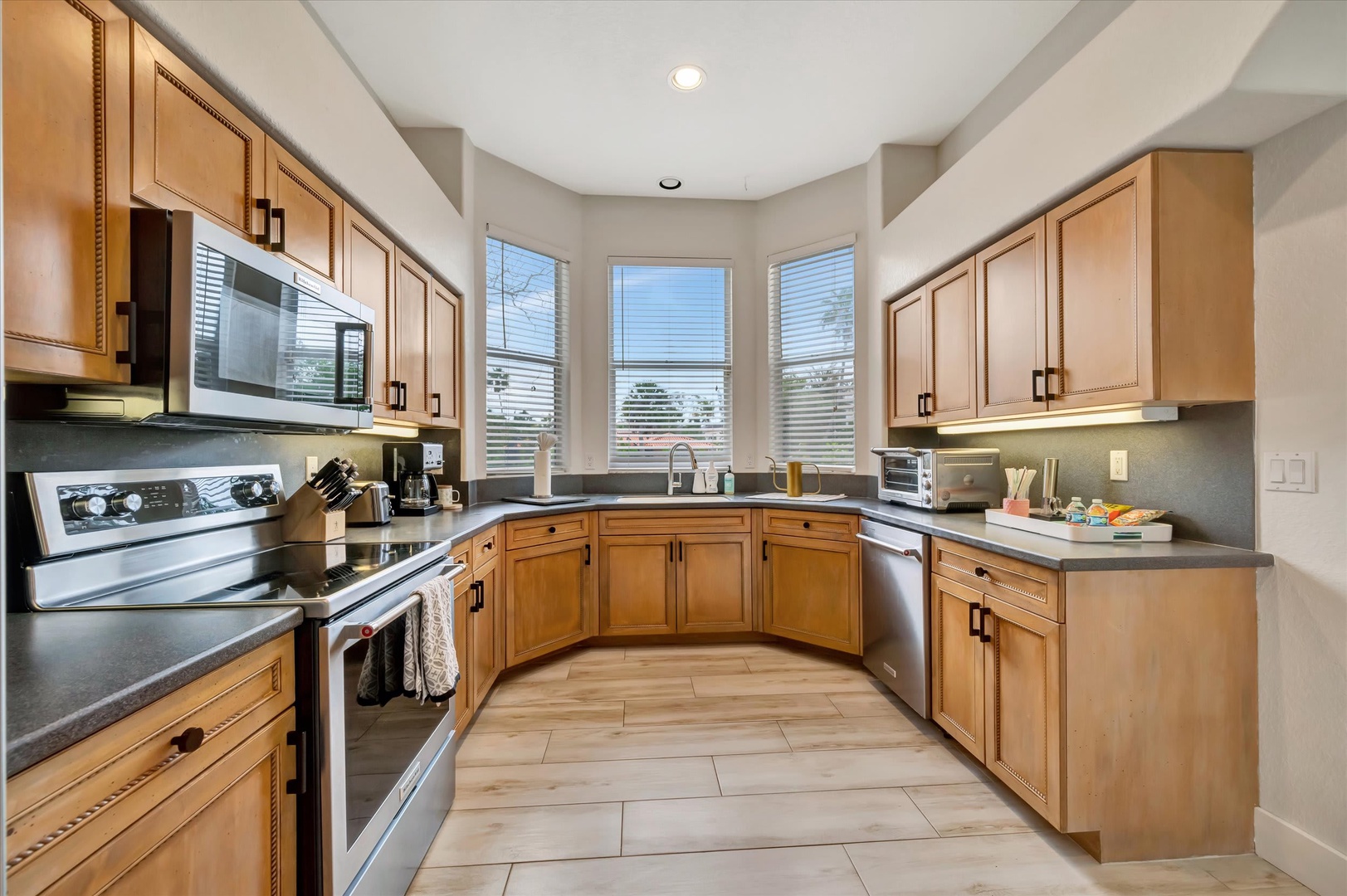 Your fully equipped kitchen welcomes you with warm wood cabinetry, sleek granite counters, and modern appliances—perfect for whipping up everything from morning coffee to leisurely dinners during your stay.