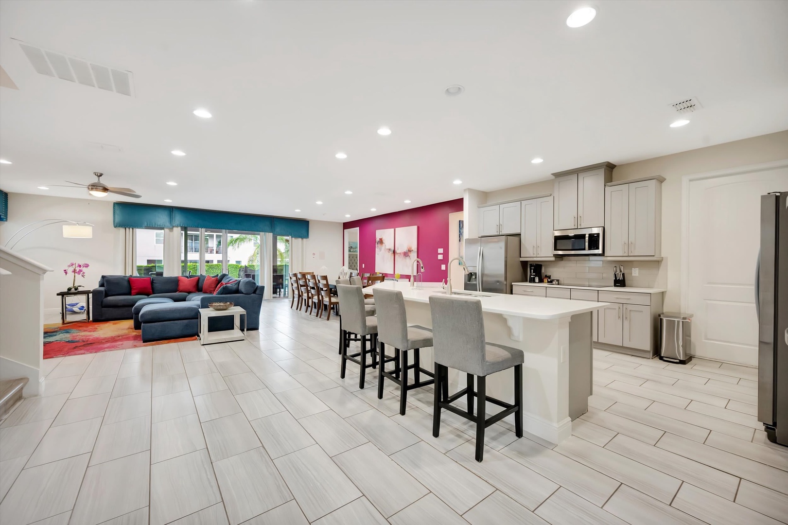 Step into your spacious open-concept living area where vibrant pops of color meet modern comfort. Gather around the kitchen island for morning coffee or unwind in the stylish lounge after a day of adventure.