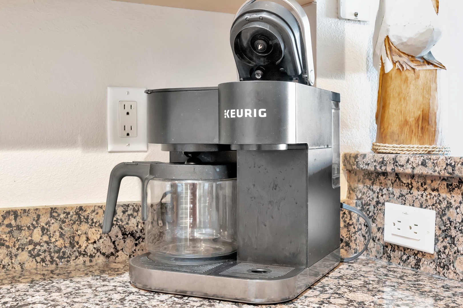 Your morning coffee awaits with this Keurig brewer on the granite counter—just add your favorite K-cup and enjoy a fresh, hot cup to start your day.