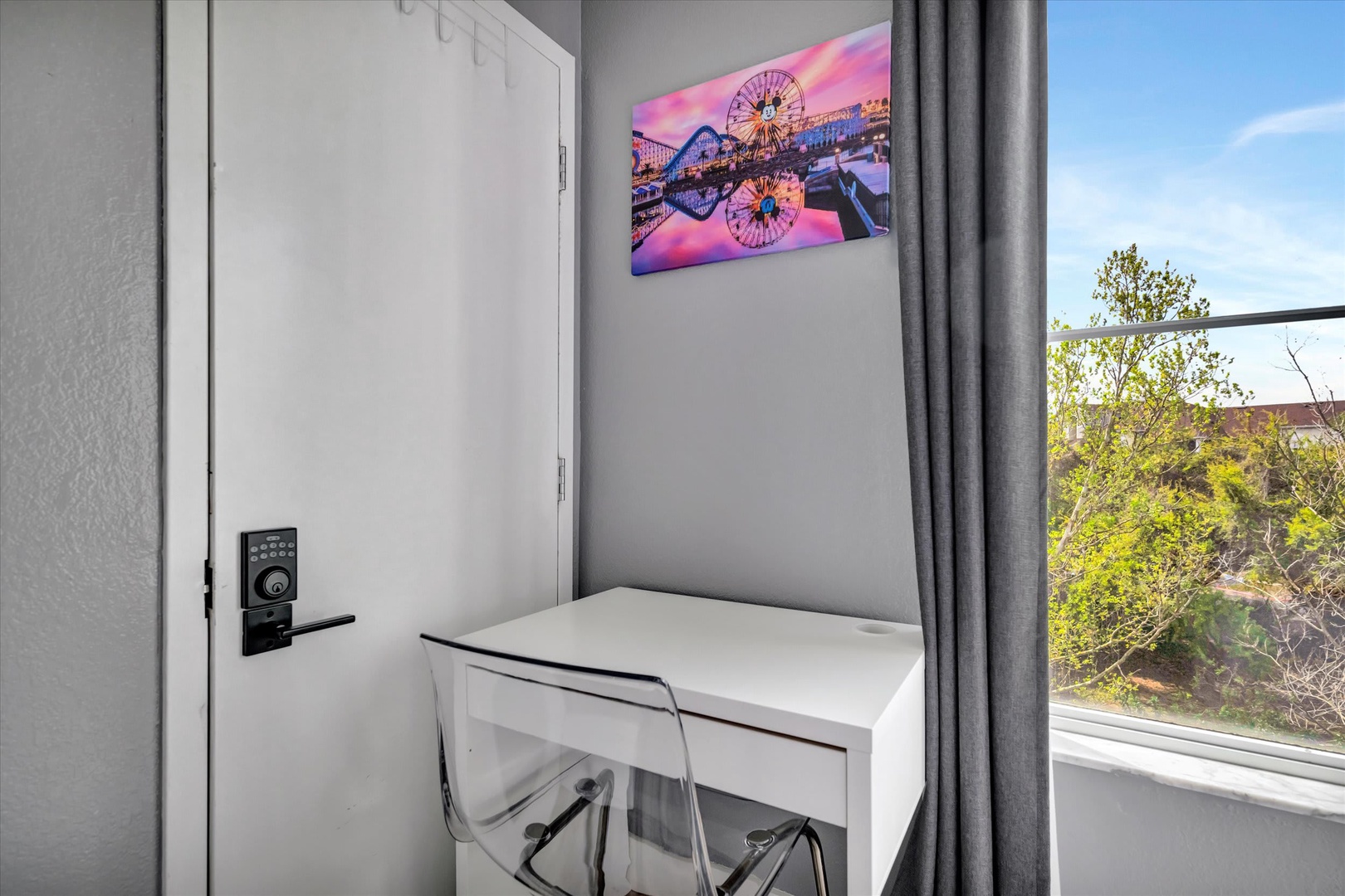 A bright workspace with a desk and chair awaits you by the window, where natural light and leafy views create an inspiring spot to work or plan your day.