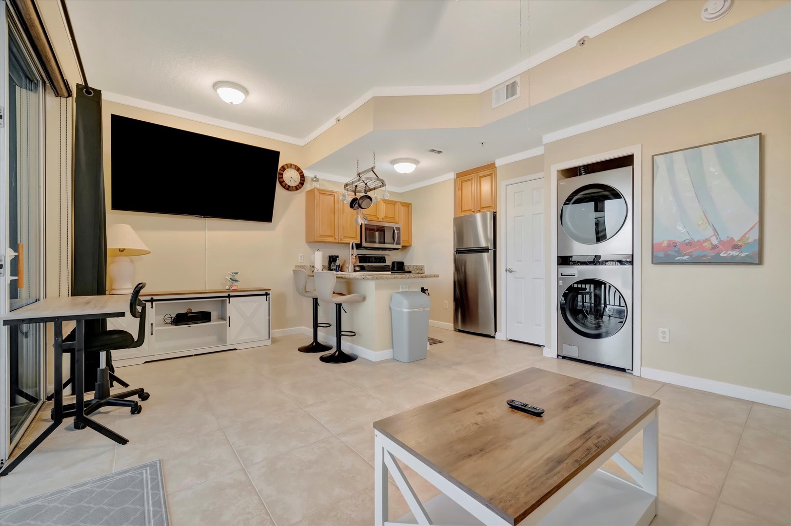 Your open-concept retreat features a fully equipped kitchen, dedicated workspace, and stacked washer-dryer—everything you need for a comfortable, extended stay.