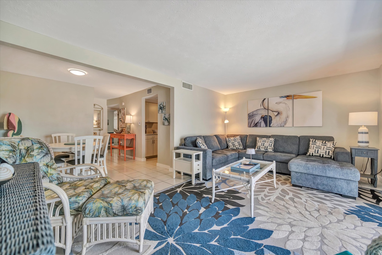 Step into your bright, open living space where comfort meets coastal charm. Sink into the plush sectional, gather around the coffee table, and let the airy layout and tropical accents set the tone for your relaxing getaway.