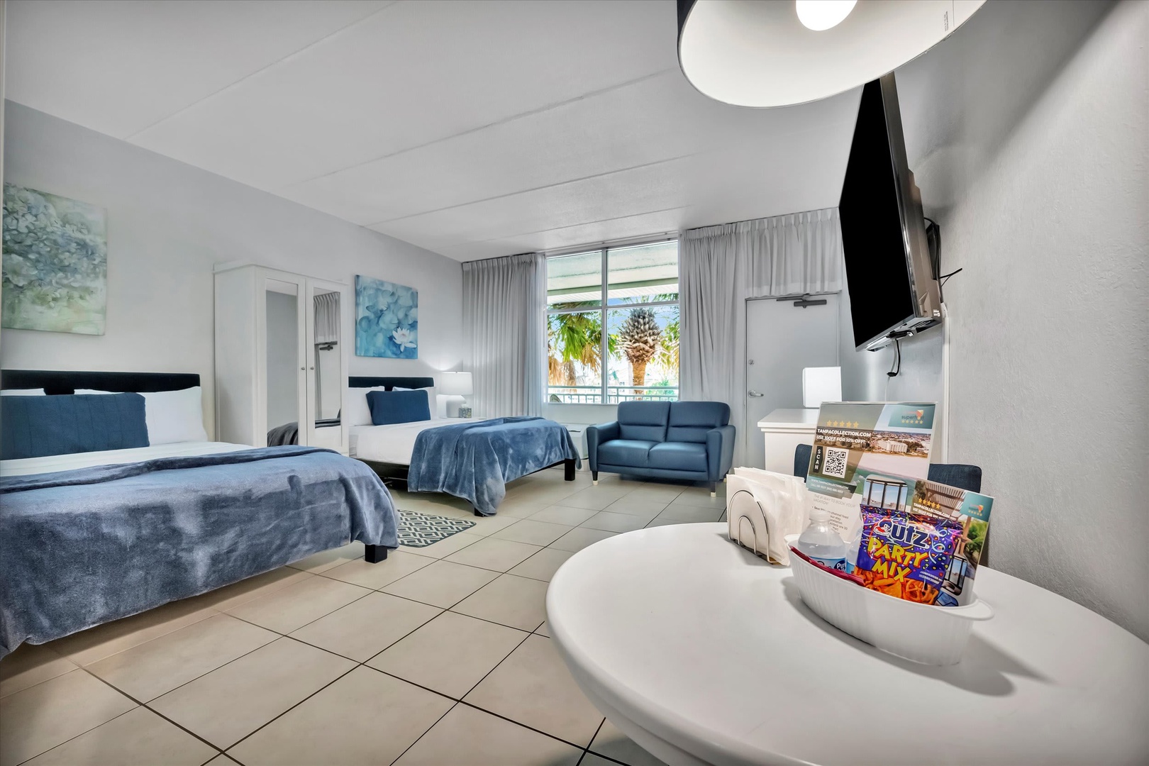 Unwind in your spacious retreat with two plush beds, a cozy sitting area, and modern touches like a flat-screen TV—everything you need for a comfortable, relaxing stay.