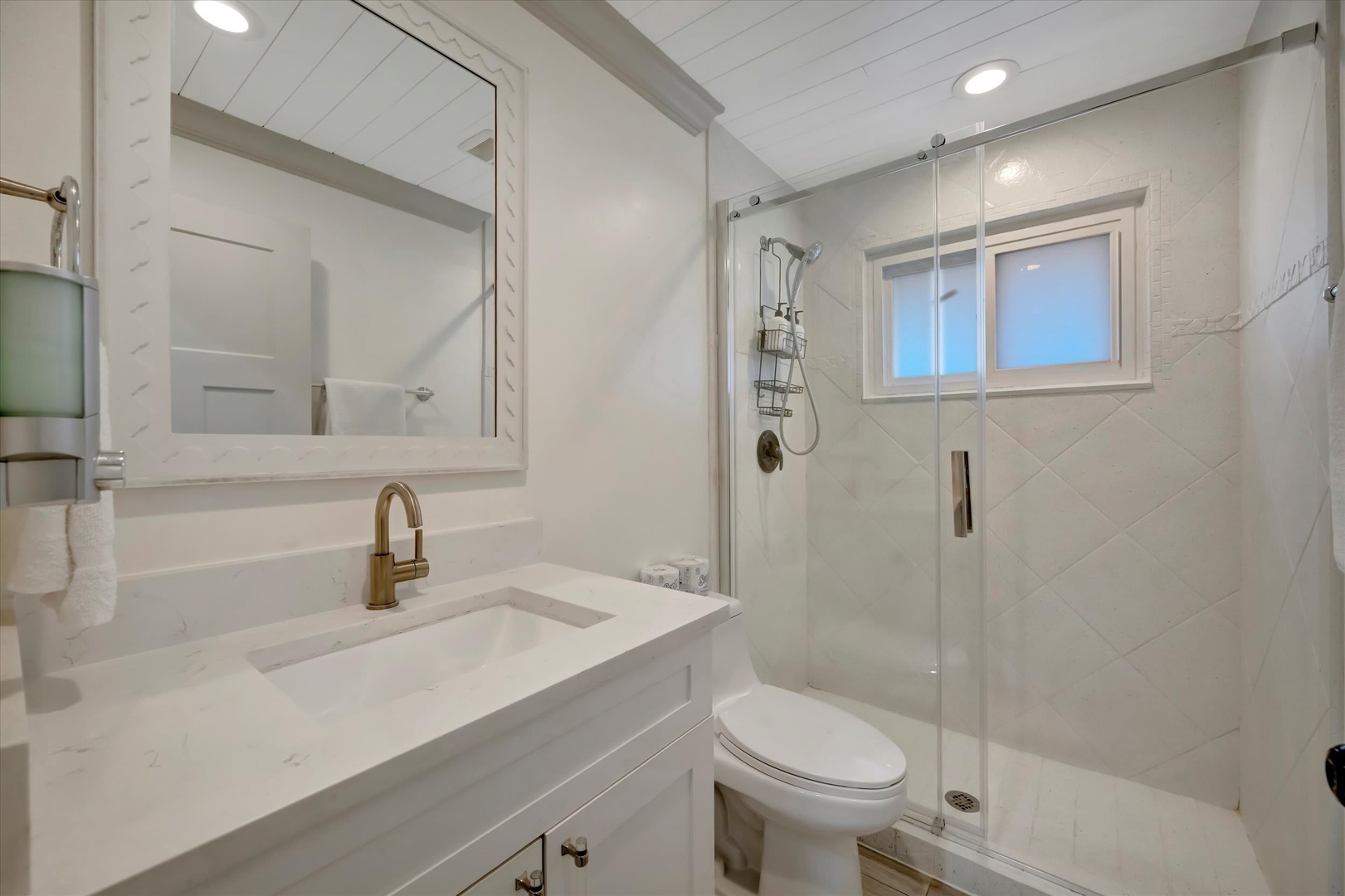 Freshen up in your beautifully updated bathroom, where bright white finishes and elegant marble create a clean, spa-like retreat after a day of exploring.