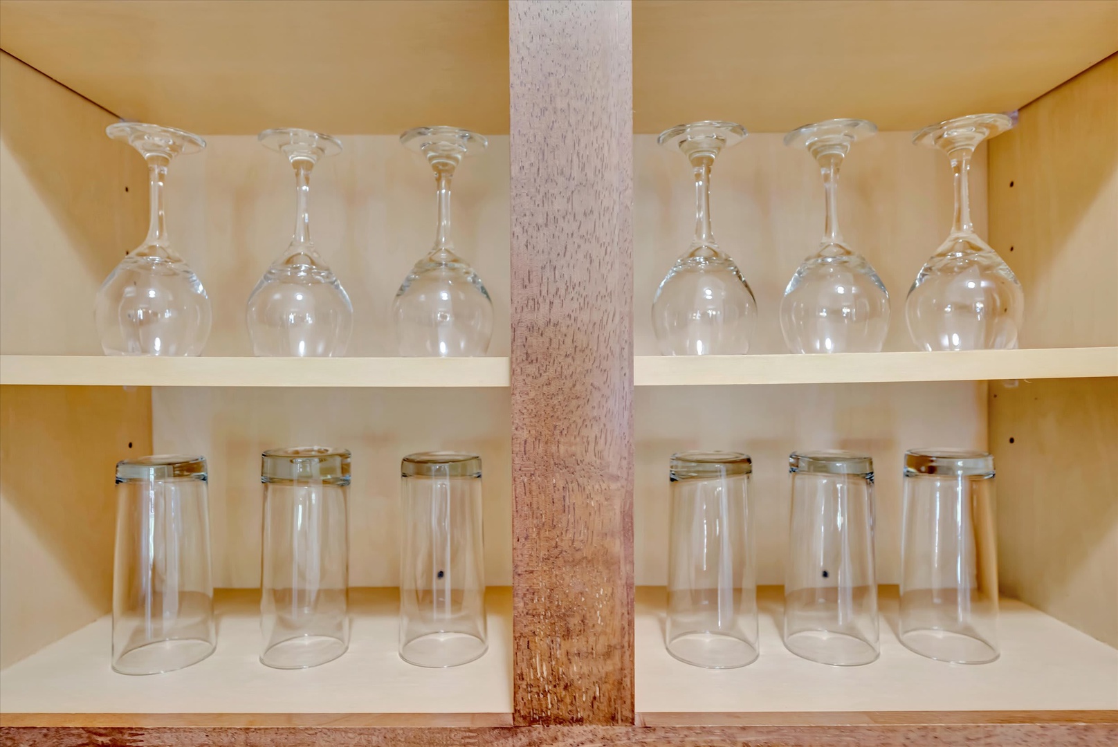 Everything you need is within reach—gleaming glassware for your evening toast and fresh mornings, neatly arranged and ready for your stay.