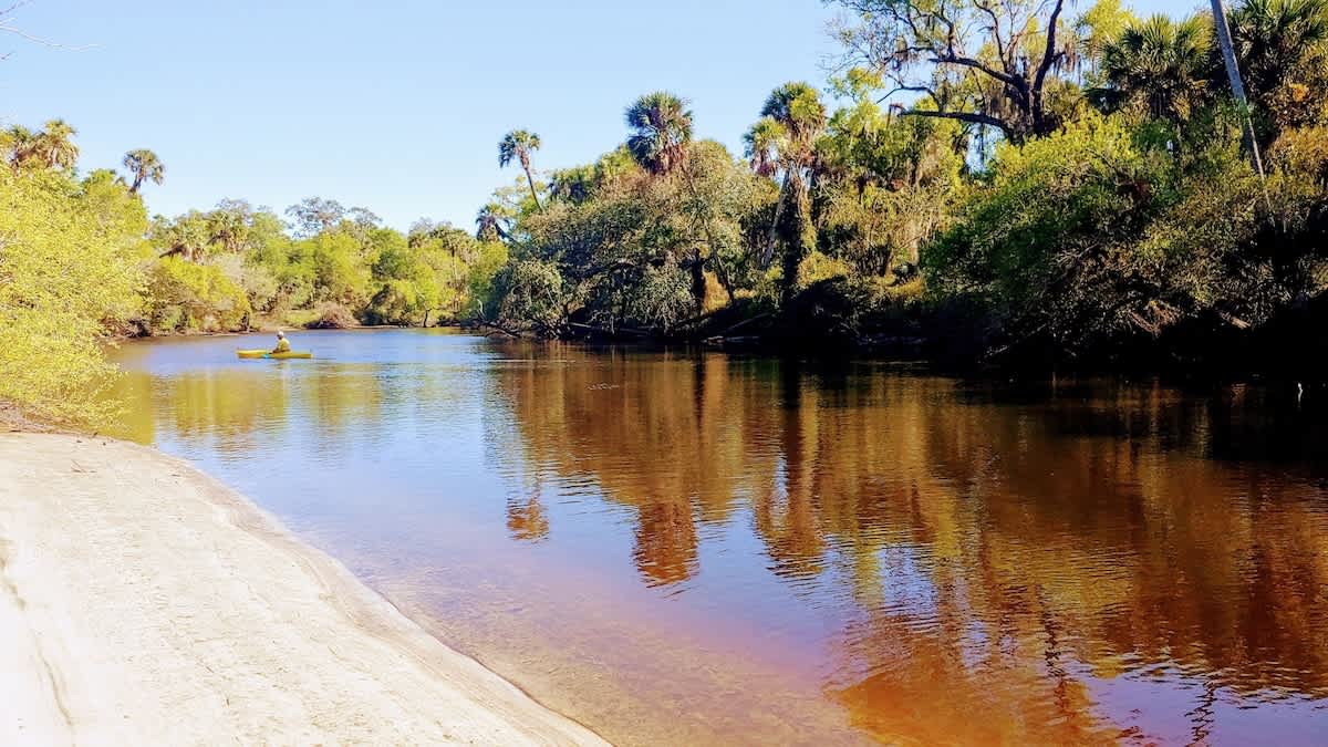 A peaceful river winds through lush natural landscape, perfect for kayaking and exploring the surrounding wilderness during your stay.