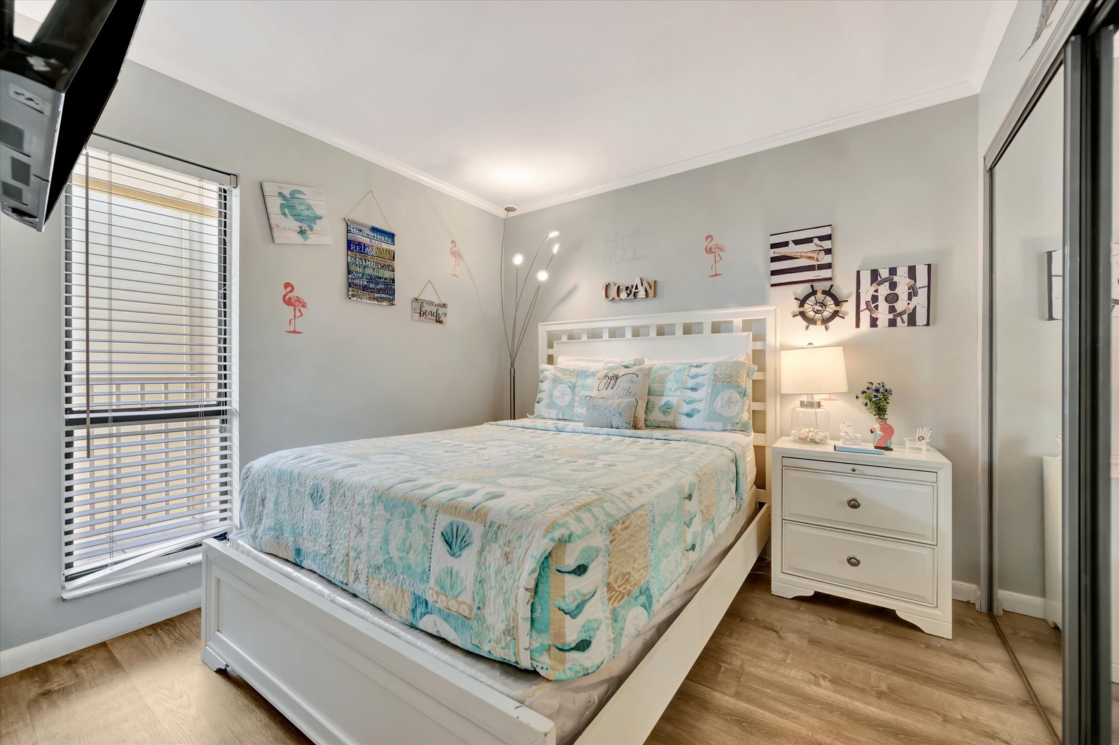 Sink into relaxation in your coastal-inspired bedroom, where beach-themed decor and bright ocean hues invite sweet dreams after a day exploring the shore.
