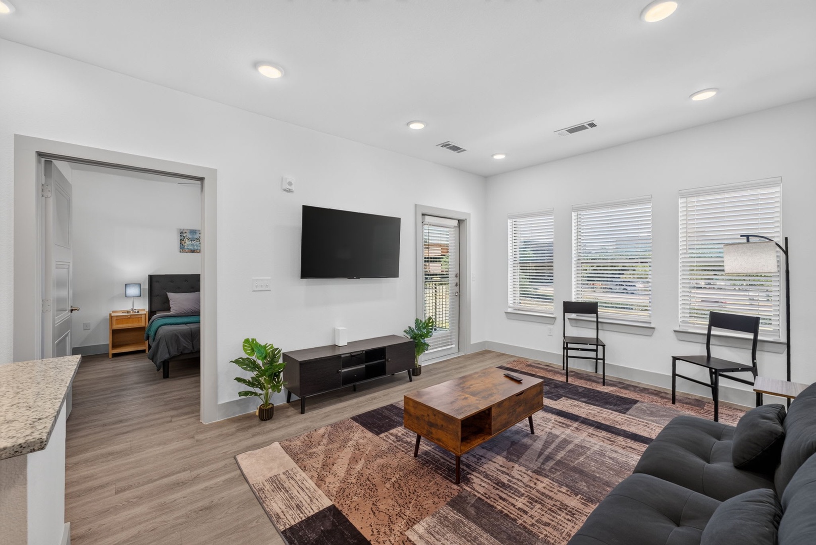 Relax in your bright, modern living space where sleek furniture and warm wood tones create the perfect setting to unwind after exploring the city.