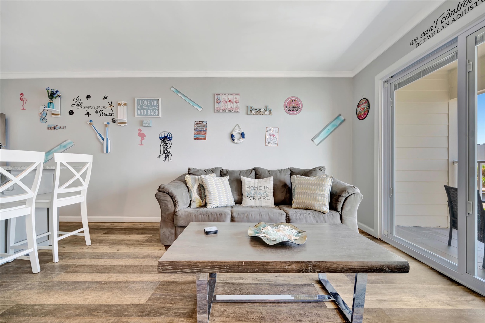 Settle into your coastal-themed living room where beachy decor and plush seating create a relaxed, welcoming retreat for your group to gather and unwind.
