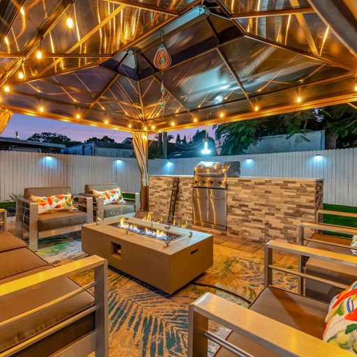 Your private oasis awaits under the stars—cozy seating, warm firelight, and twinkling lights overhead create the perfect setting for unforgettable evenings outdoors.