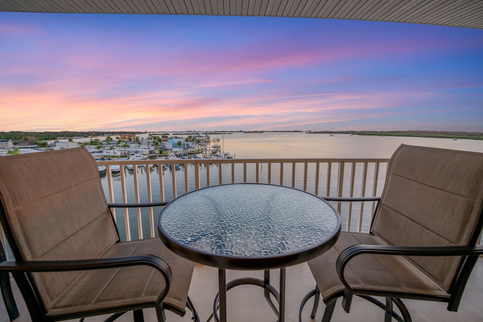 Watch the sky transform with soft pinks and lavenders as you settle into your private balcony, where waterfront calm and wide-open views create the perfect retreat for your morning coffee or evening wind-down.
