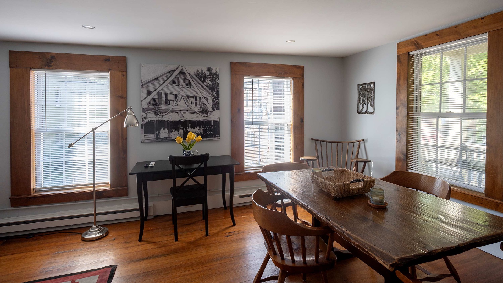 Step into your bright dining and workspace, where warm wood trim frames peaceful views and natural light fills the room. The solid wood table invites shared meals and conversation.