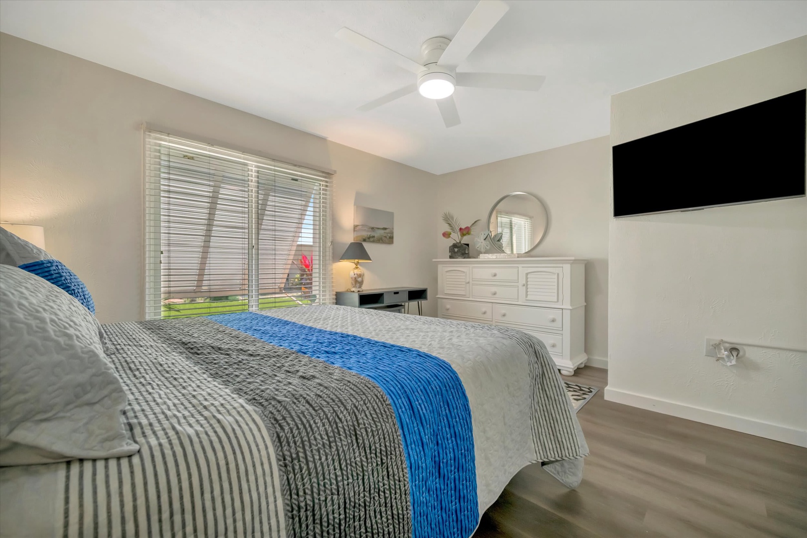 Relax in your bright and airy bedroom with ceiling fan, comfortable linens, and a TV for your entertainment. The garden view from your window adds a refreshing touch.