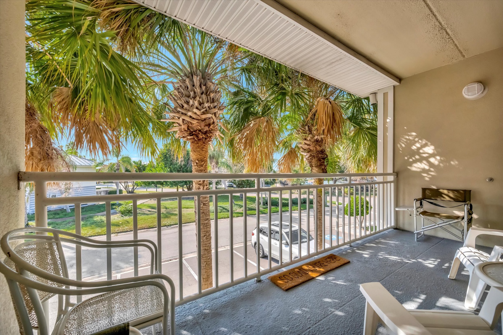 Step onto your private balcony and feel the desert warmth as you take in swaying palms and lush greenery beyond—a peaceful retreat where your mornings begin with blue skies and gentle shade.