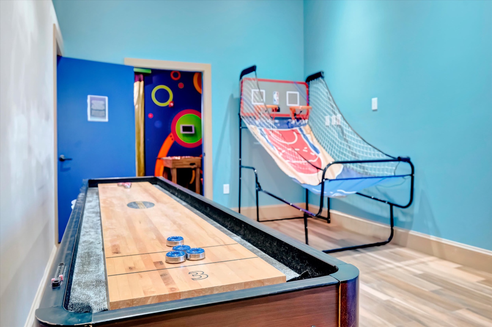 Your own private game room awaits, complete with shuffleboard and arcade basketball—perfect for some friendly competition and endless fun during your stay.