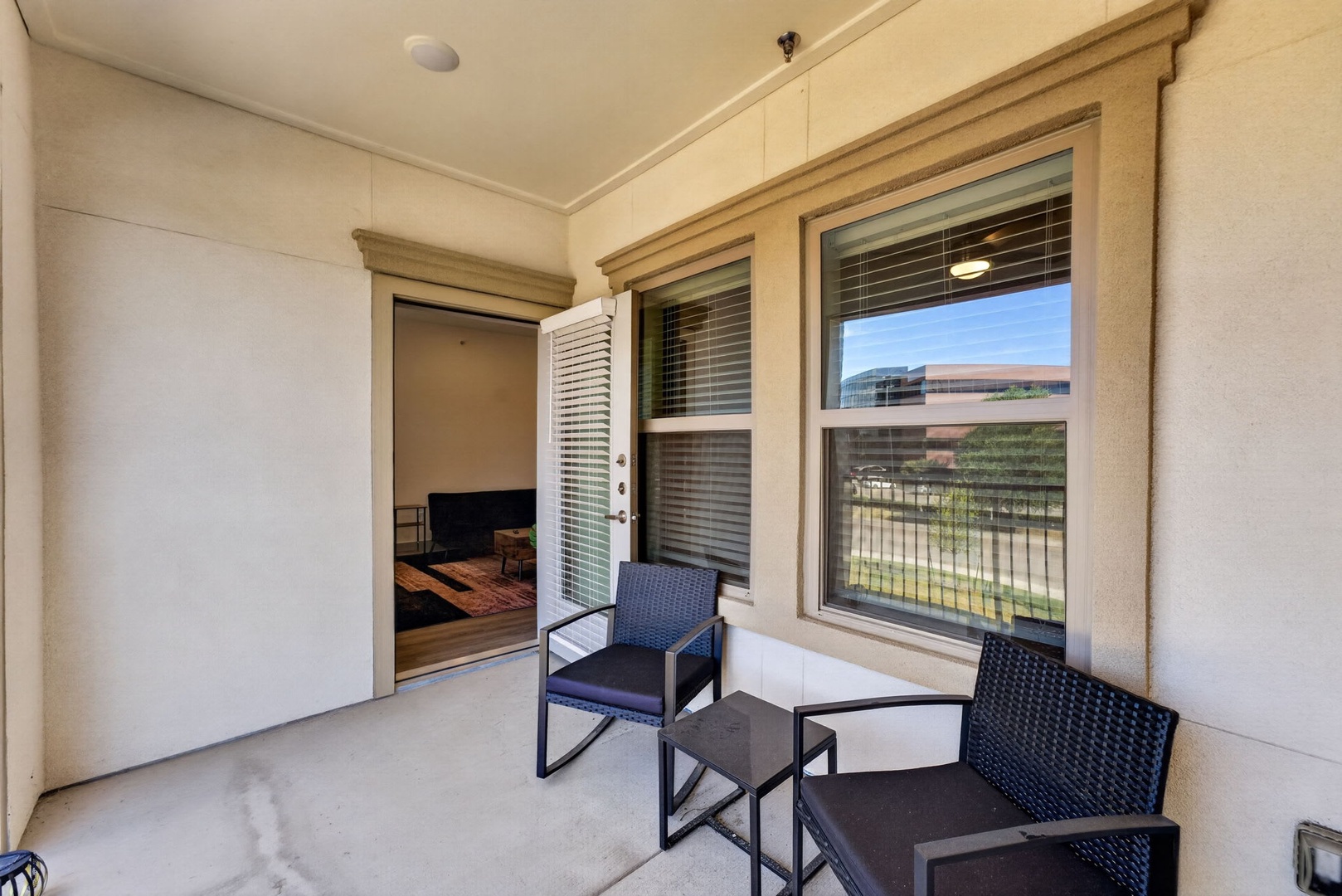 Your private covered patio offers a peaceful spot to relax with morning coffee or evening conversation, complete with comfortable seating and views of the surrounding area.