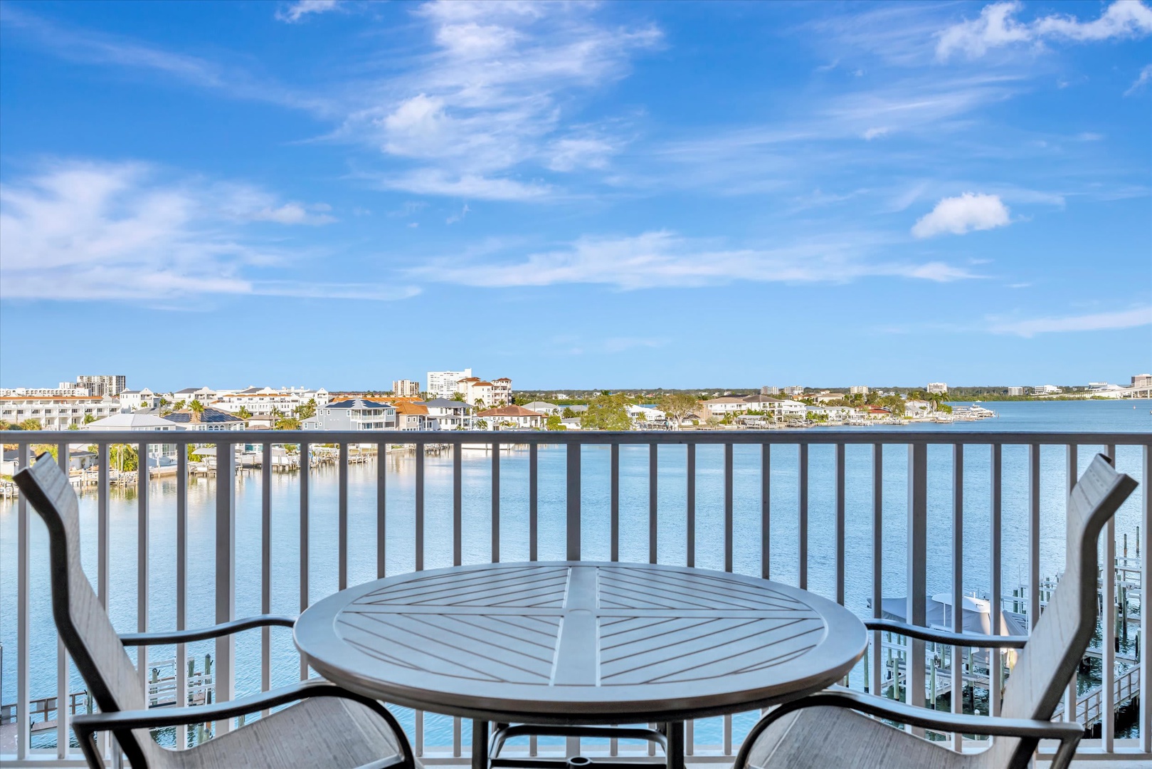 Step out onto your private balcony and soak in stunning waterfront views. Enjoy morning coffee or evening cocktails at your outdoor table while taking in the sparkling water and coastal skyline.