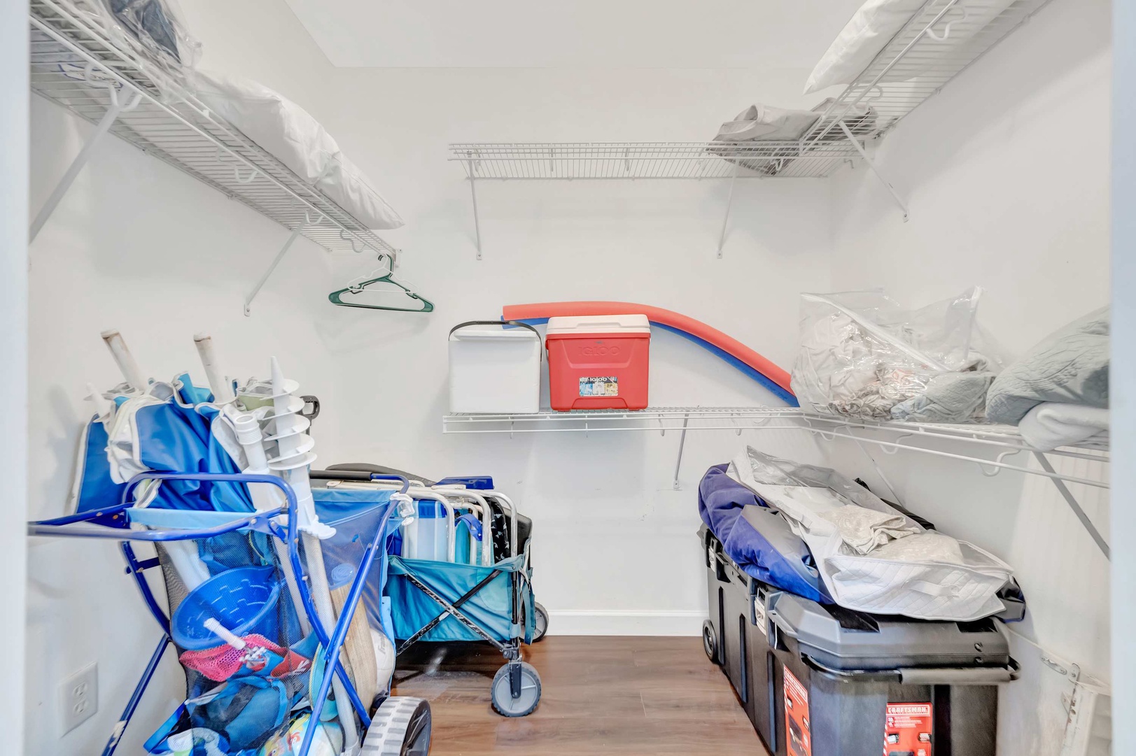 A dedicated storage closet with organized shelving keeps your beach gear and belongings neatly tucked away during your stay.