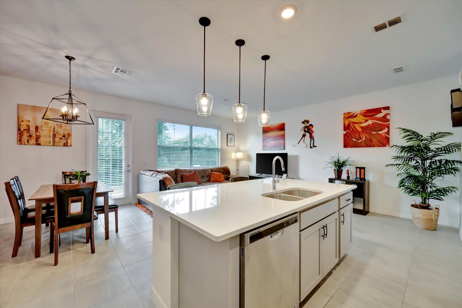 Step into your bright, open living space where the kitchen island becomes your gathering spot. Sunlight pours through tall windows, illuminating gleaming countertops and modern fixtures—perfect for cooking and connecting with loved ones.