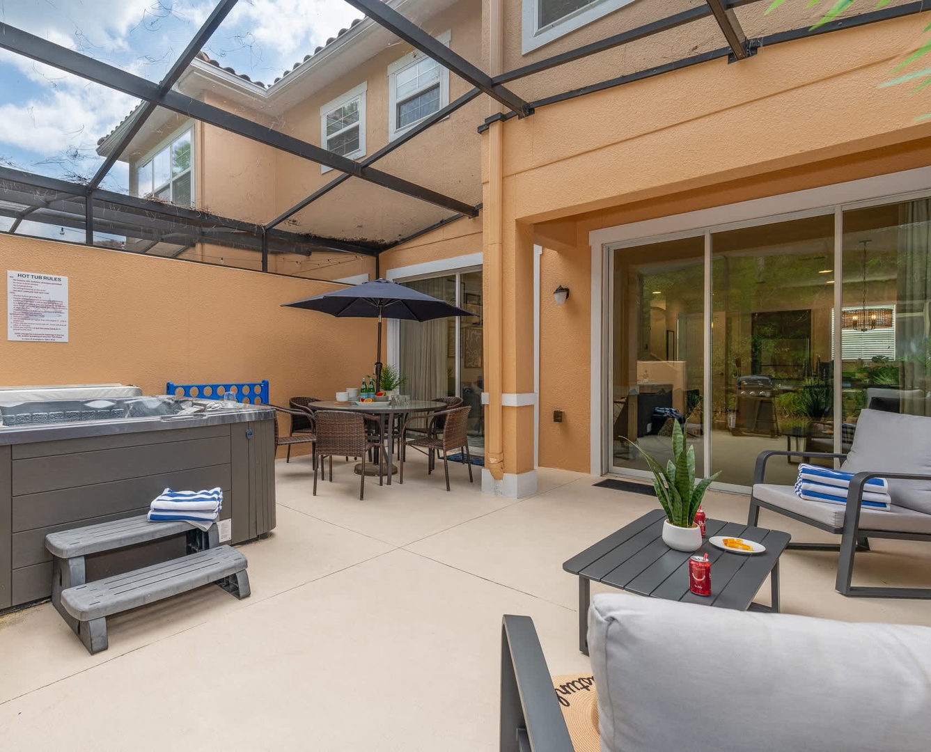 Your private outdoor retreat awaits with a hot tub, covered dining area, and comfortable lounge seating—perfect for unwinding under the Florida sun or soaking away the day's adventures.