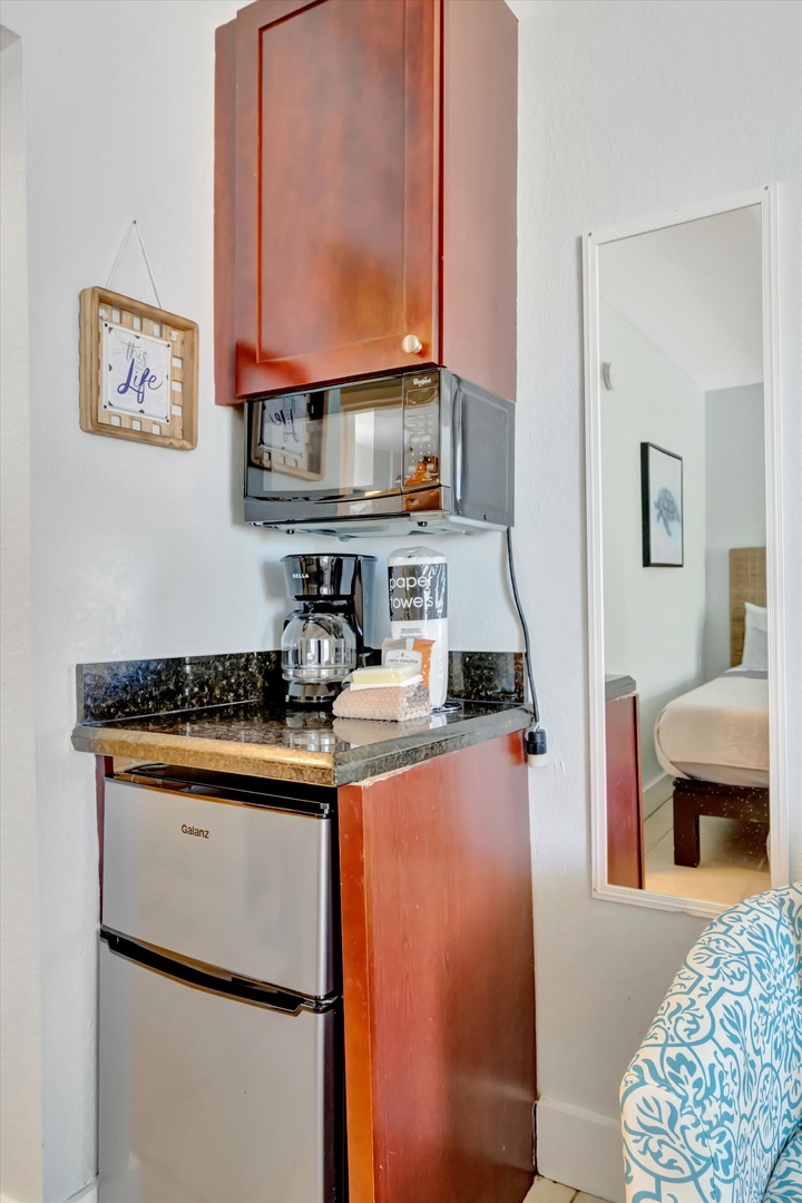 Your private kitchenette awaits—complete with a mini-fridge, microwave, and coffee maker, all tucked neatly into a cozy corner for easy morning starts and late-night snacks.