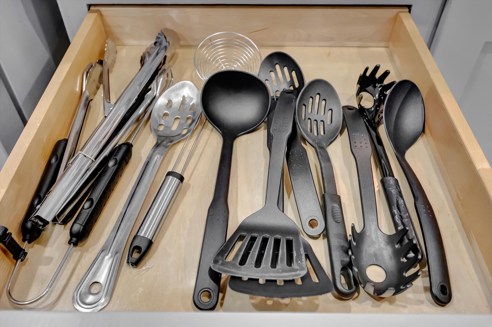 Your well-stocked kitchen drawer features an array of quality utensils, from slotted spoons and ladles to tongs and serving tools—everything you need to prepare memorable meals during your stay.