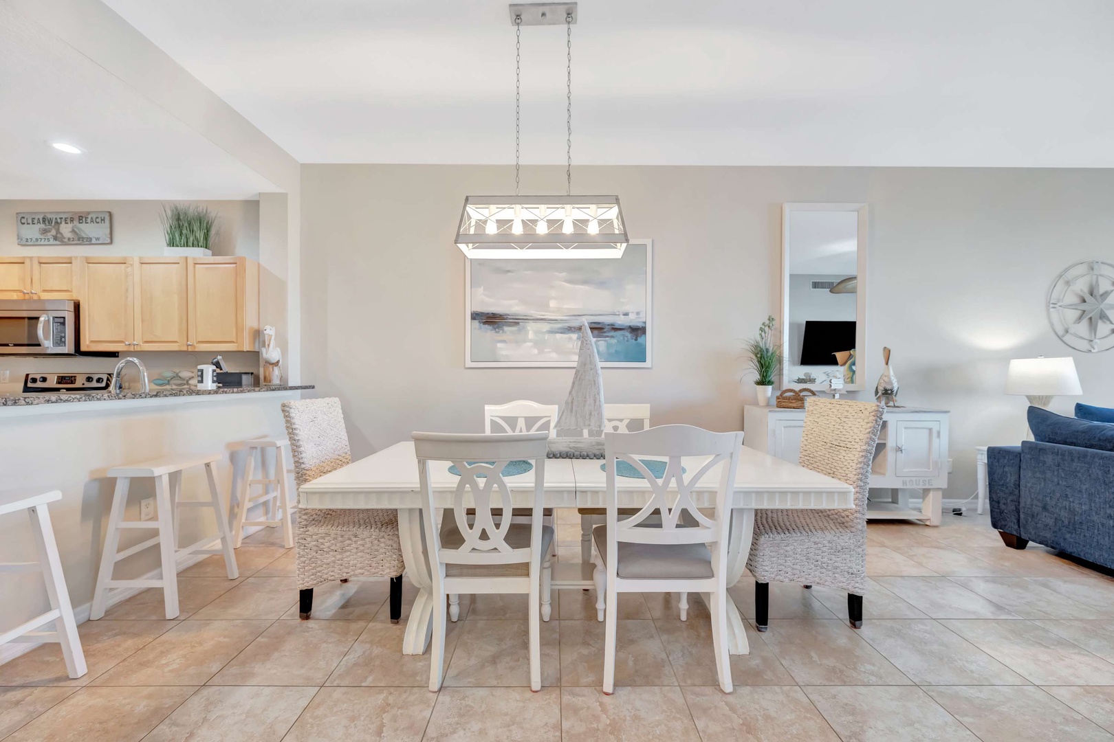 Gather around your bright, open dining area where coastal charm meets comfort. With seating for six and seamless flow into the kitchen and living room, you'll love spending time here.