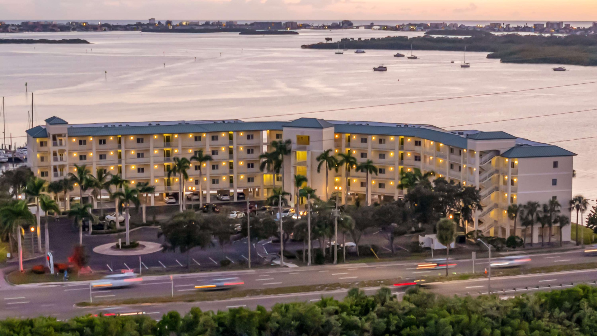 Modern beachfront resort situated along calm coastal waters with nearby islands and marinas, offering convenient access to the surrounding area's waterfront attractions.