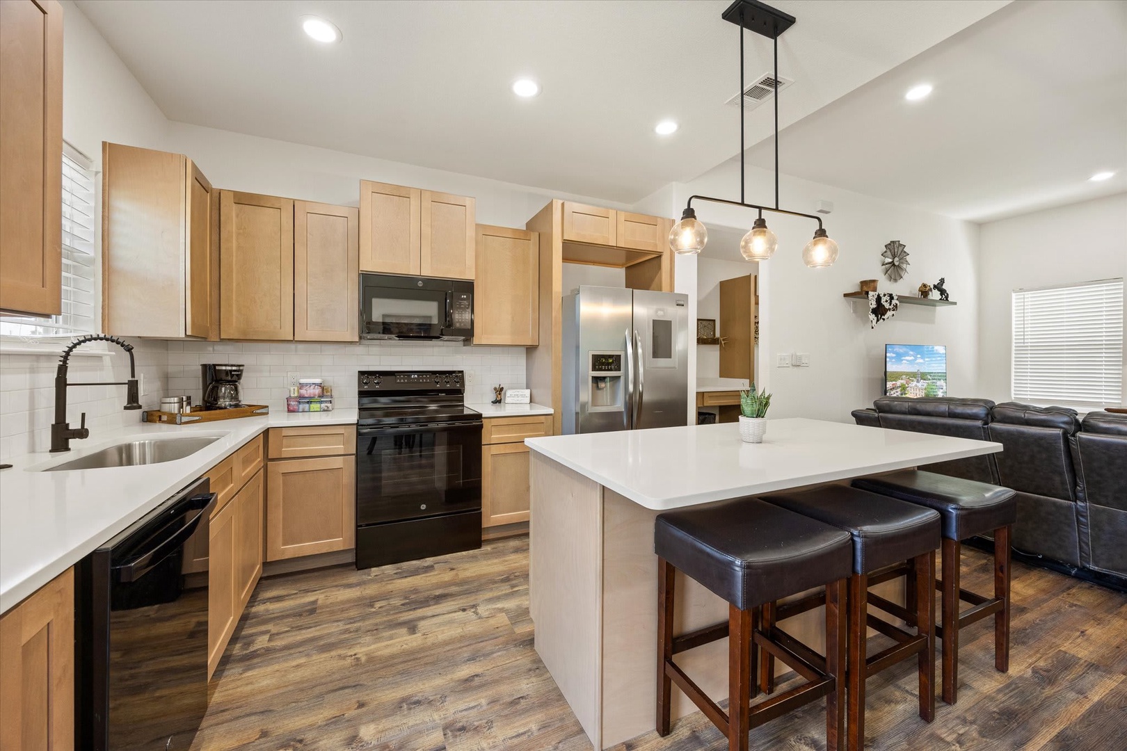 Gather around the bright island in this welcoming open-concept space, where your group can cook, share stories, and unwind together in modern comfort.
