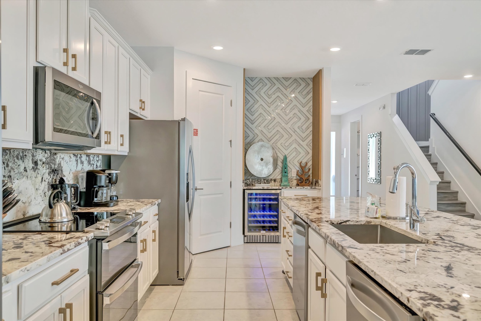 Step into your stylish kitchen with gleaming granite counters, stainless appliances, and a beverage fridge stocked for your convenience. Bright, modern, and ready for cooking or morning coffee.