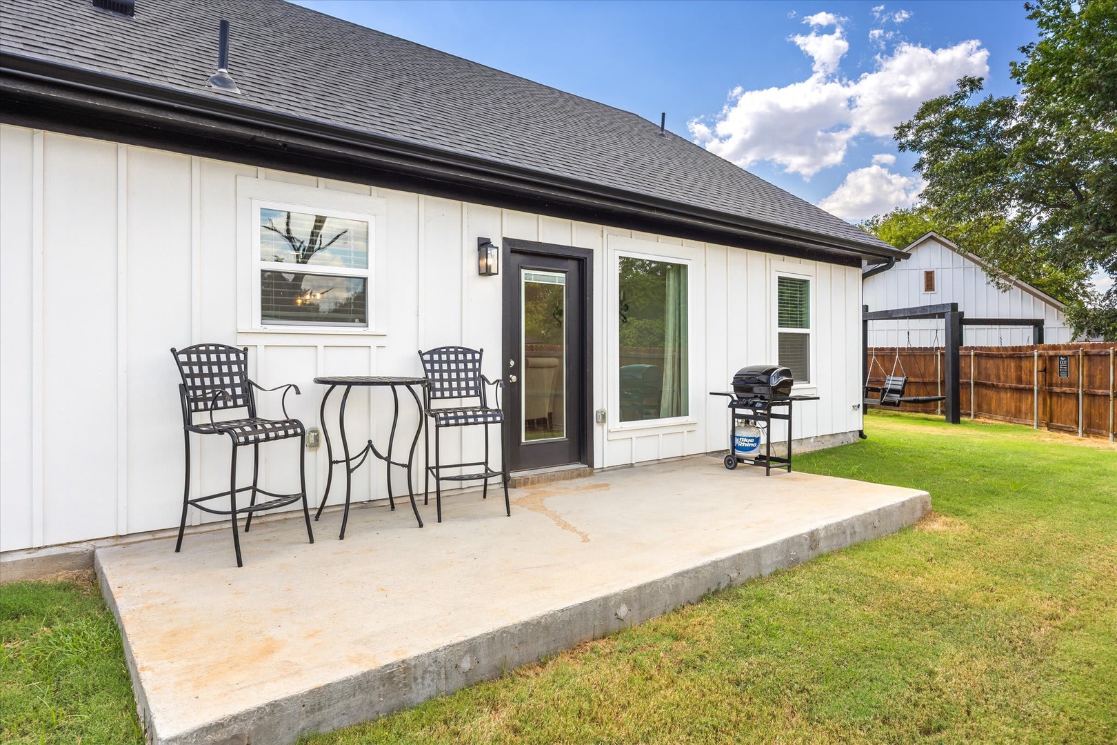 Step onto your private patio—perfect for morning coffee at the bistro table or grilling your favorite meal. The spacious lawn and peaceful backyard setting invite you to unwind in comfort.