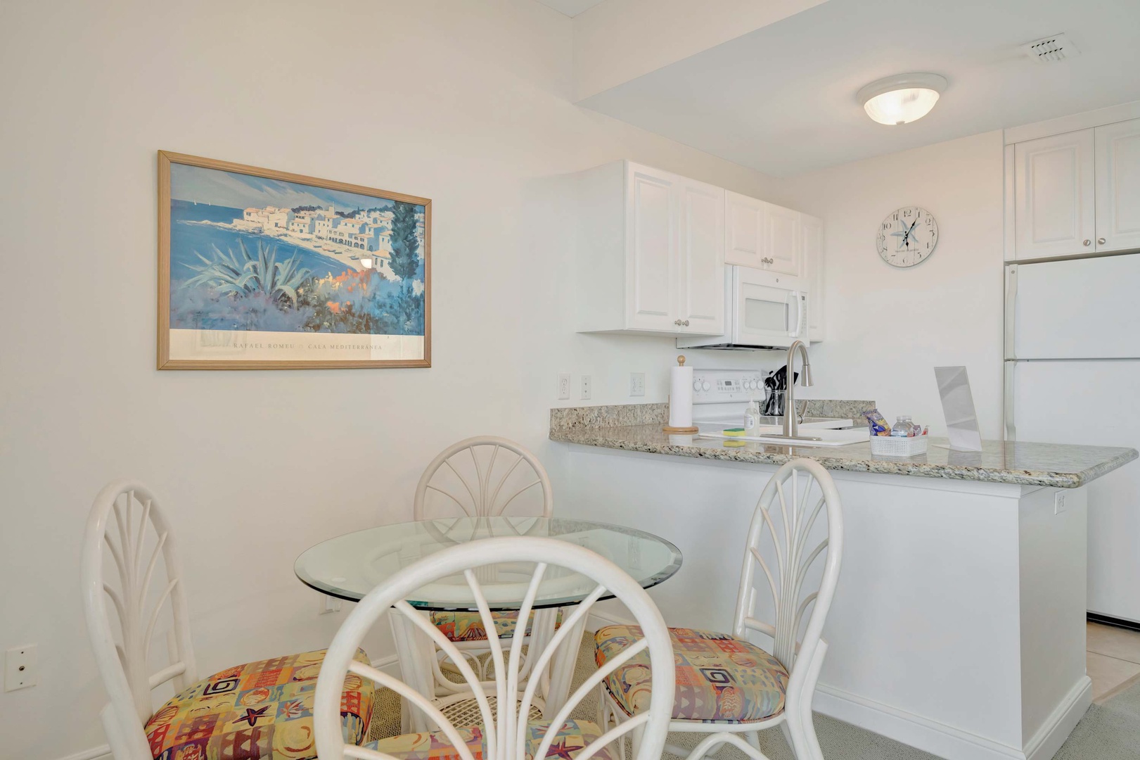 A bright, welcoming space where you can whip up your favorite meals in this fully-equipped kitchen before gathering at the cozy dining table for memorable conversations.