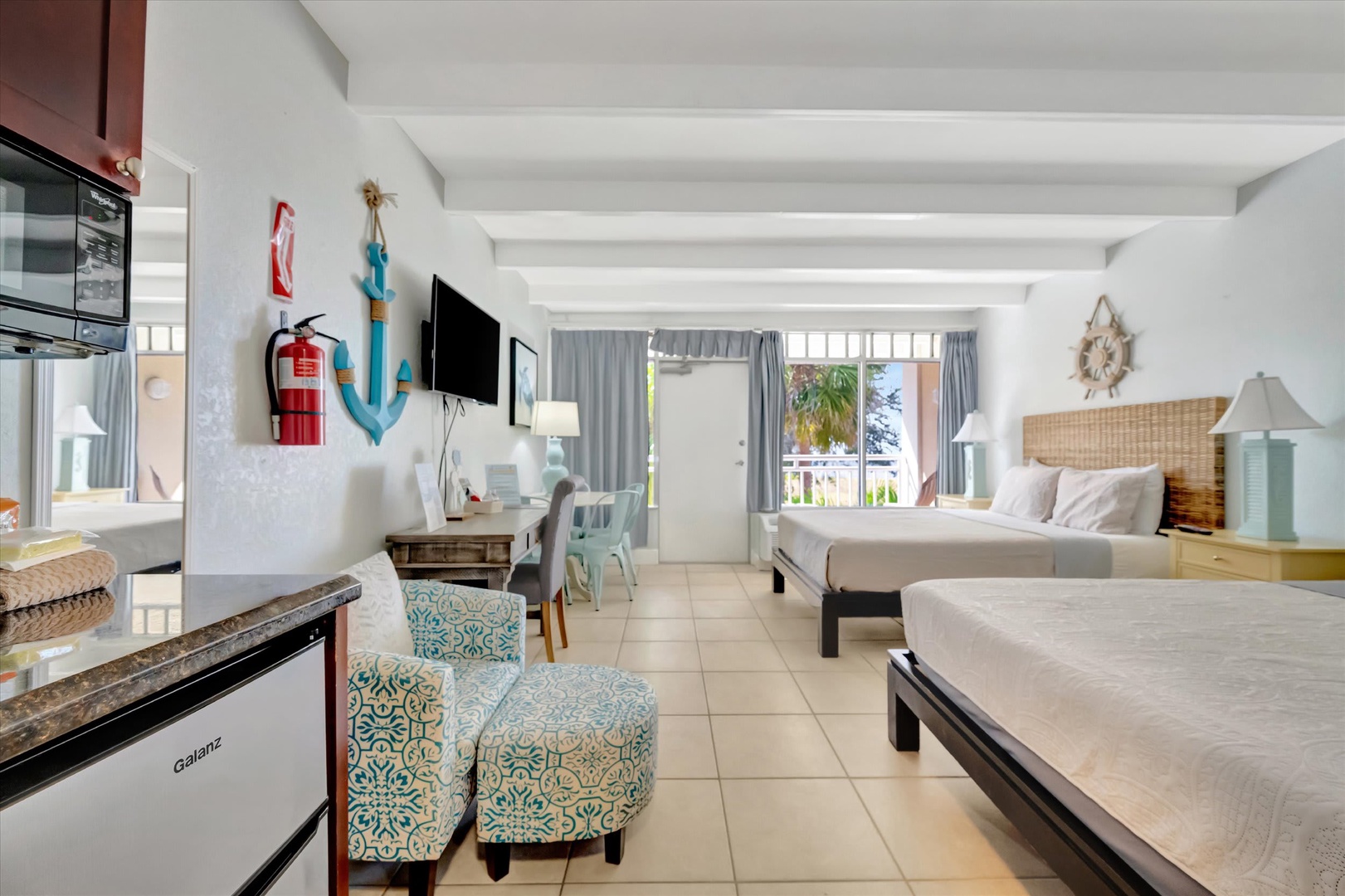 Step into your bright coastal suite where beach-chic style meets comfort. Two plush beds and a fully-equipped kitchenette make this your perfect home base for seaside adventures.