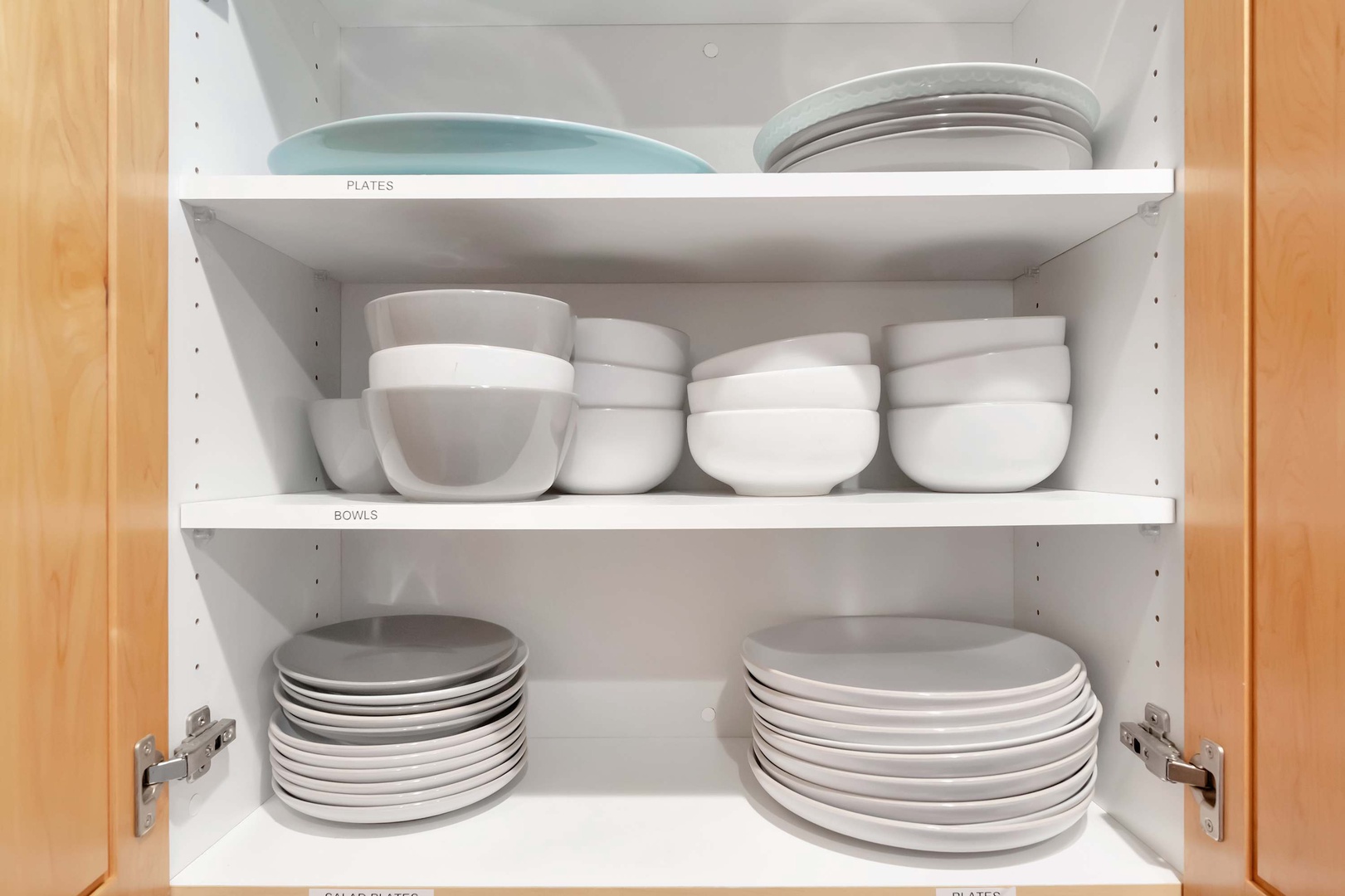 Your kitchen comes stocked with everything you need—neatly organized plates, bowls, and dinnerware ready for easy meal prep and serving.