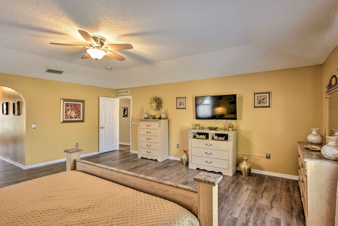Your spacious bedroom awaits with warm golden tones and all the comforts of home. Ceiling fan keeps you cool, while thoughtful storage and welcoming décor help you settle in and unwind after a day of adventure.