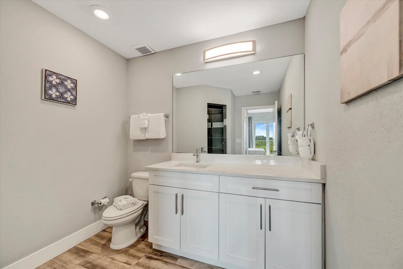 Step into your sleek, modern bathroom featuring a spacious vanity, crisp white finishes, and soft lighting that makes every morning feel effortless and refreshing.