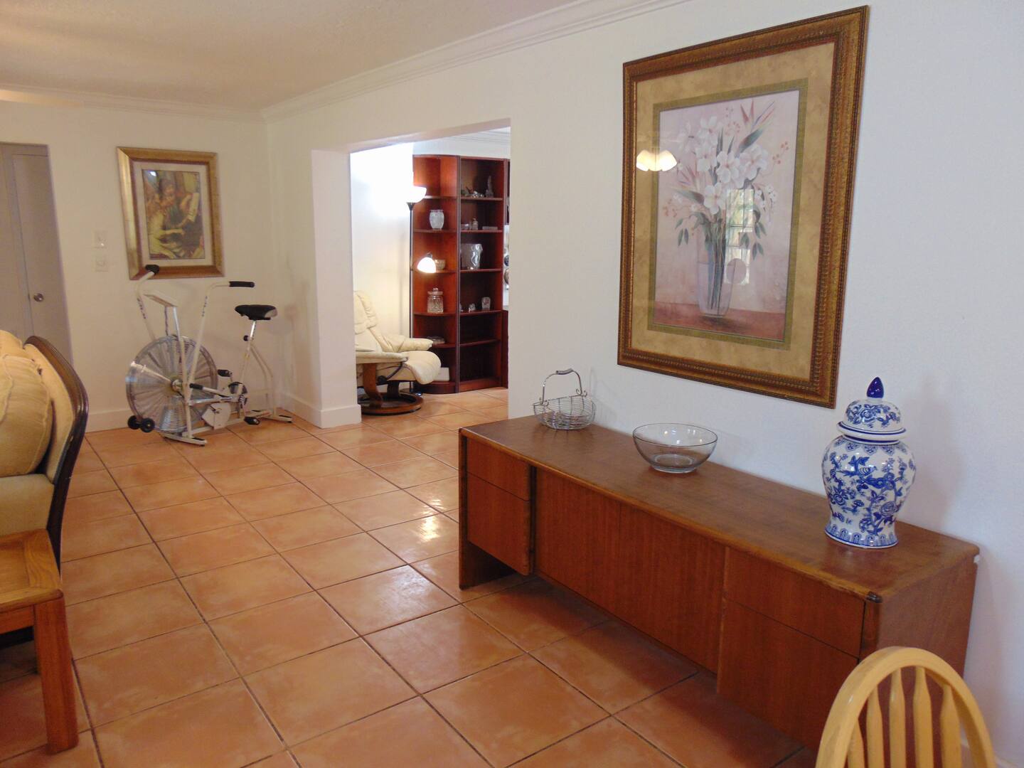 Your spacious living area invites you to settle in and unwind, with warm tile floors, elegant furnishings, and plenty of natural light flowing through from room to room.