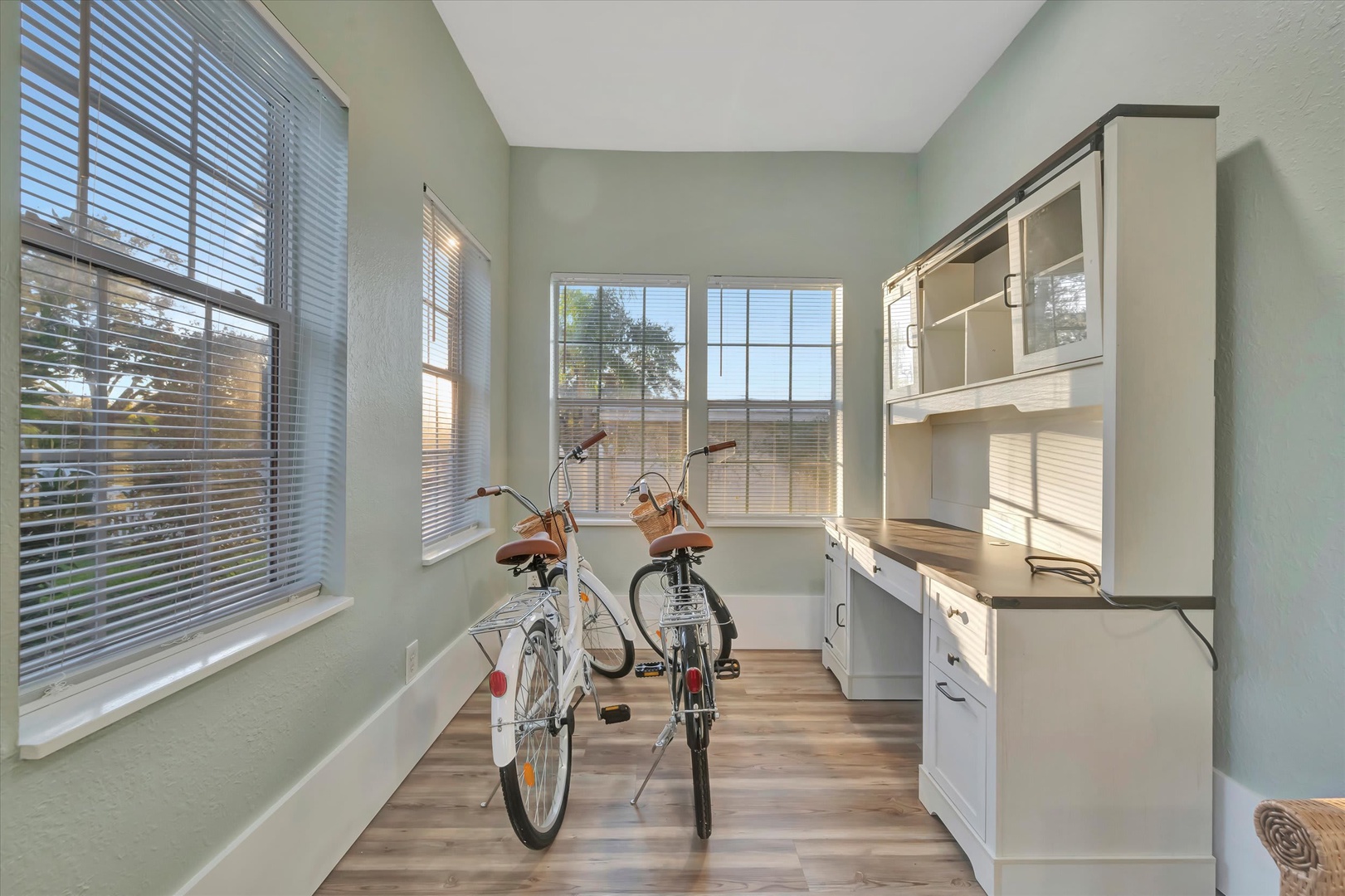 Your versatile workspace with custom built-in storage and natural light flooding through multiple windows—perfect for staying organized or preparing your bikes for a day of local exploration.