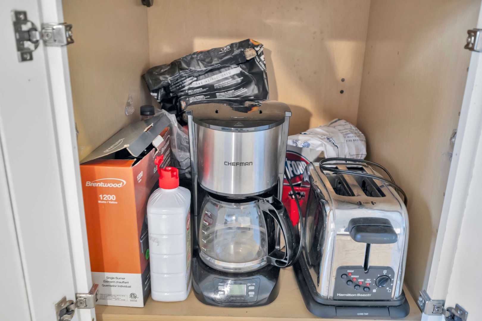 Your morning coffee awaits with a Chefman brewer and Hamilton Beach toaster ready for breakfast. Everything is conveniently organized for easy access during your stay.