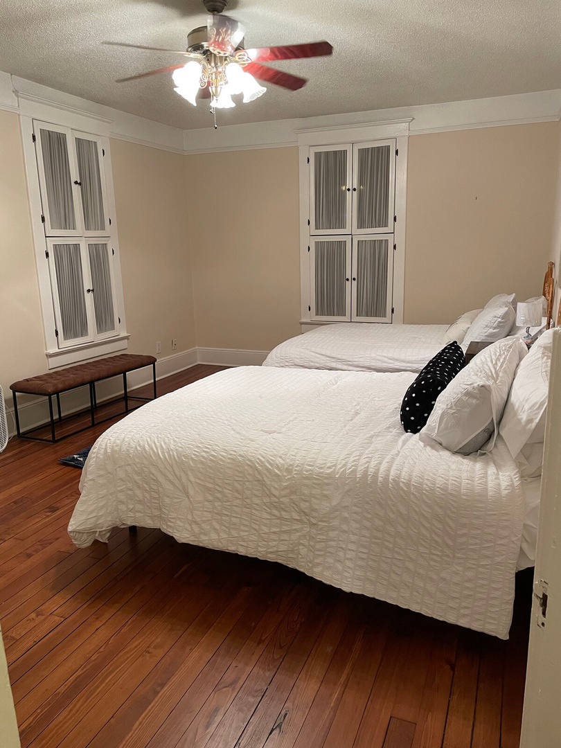 Sink into crisp white linens after a day of adventure. Warm wood floors, a ceiling fan, and generous storage keep your space comfortable and organized throughout your stay.
