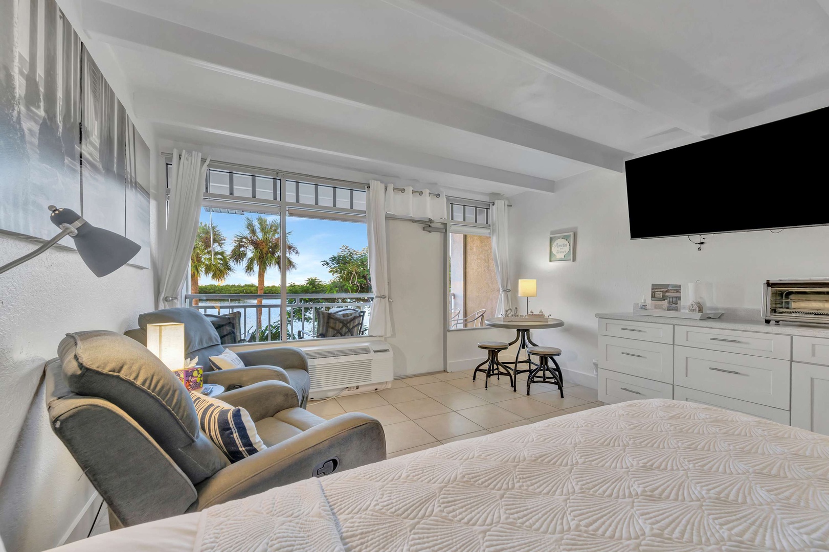 Wake up to this bright, breezy suite where palm trees sway just beyond your window and a cozy bed beckons you for a restful stay. Step outside to your balcony and soak in the tropical serenity.
