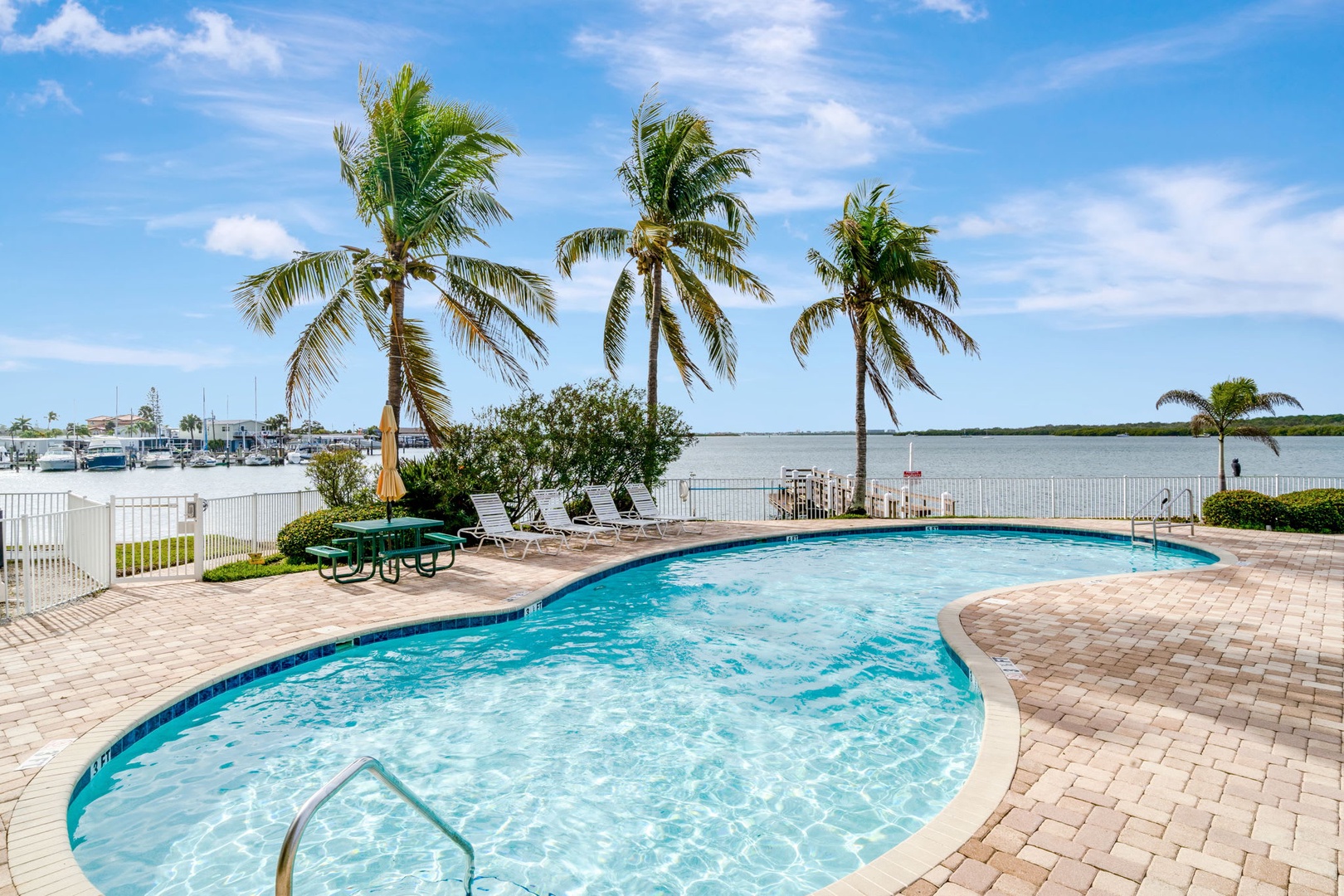 Cool off in your private waterfront pool, where swaying palms frame stunning marina views. Unwind on a sunbed, watch the boats glide by, and soak in the Florida sunshine.