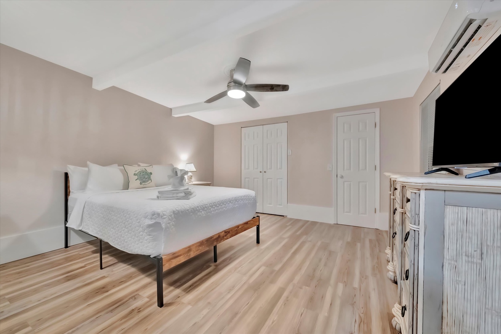 Unwind in your spacious bedroom, where a plush bed, gentle ceiling fan, and modern comforts await to make your stay truly restful.
