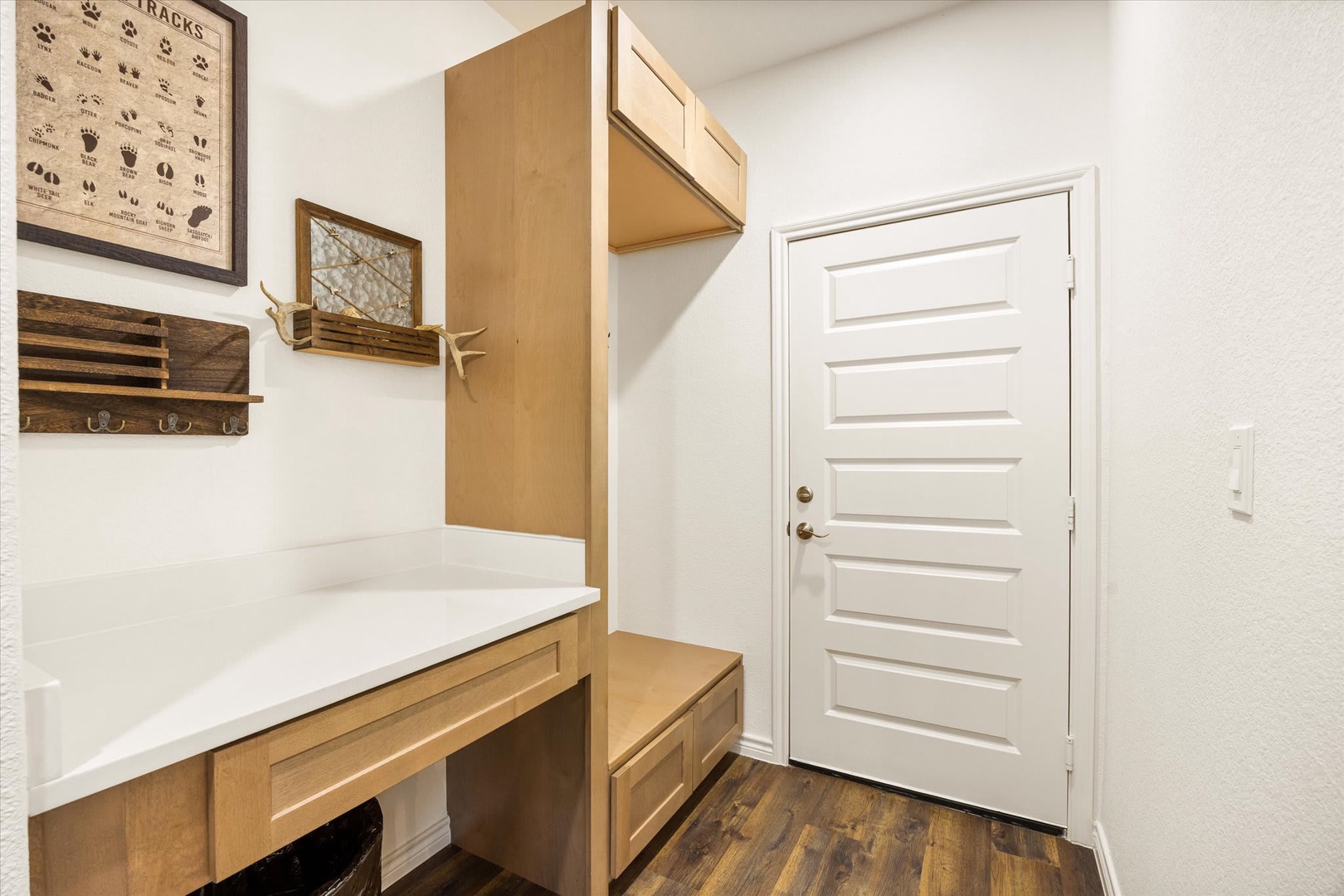 Step into your organized entry mudroom with built-in cabinetry, a convenient bench, and hooks to keep your gear perfectly stowed after a day of adventure.