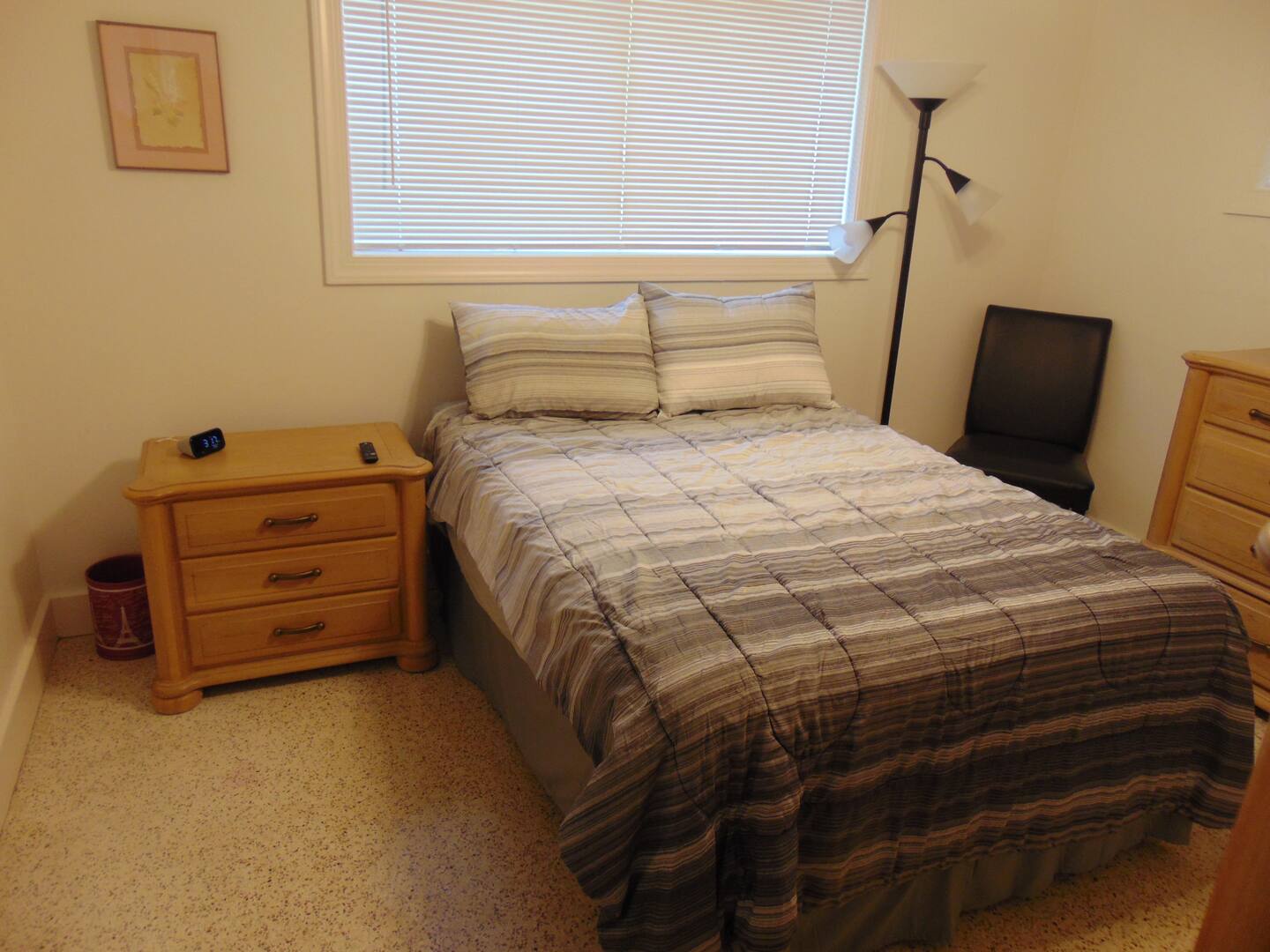 Your cozy bedroom offers a comfortable bed and everything you need to unwind, with warm natural light and thoughtful touches to help you feel right at home.