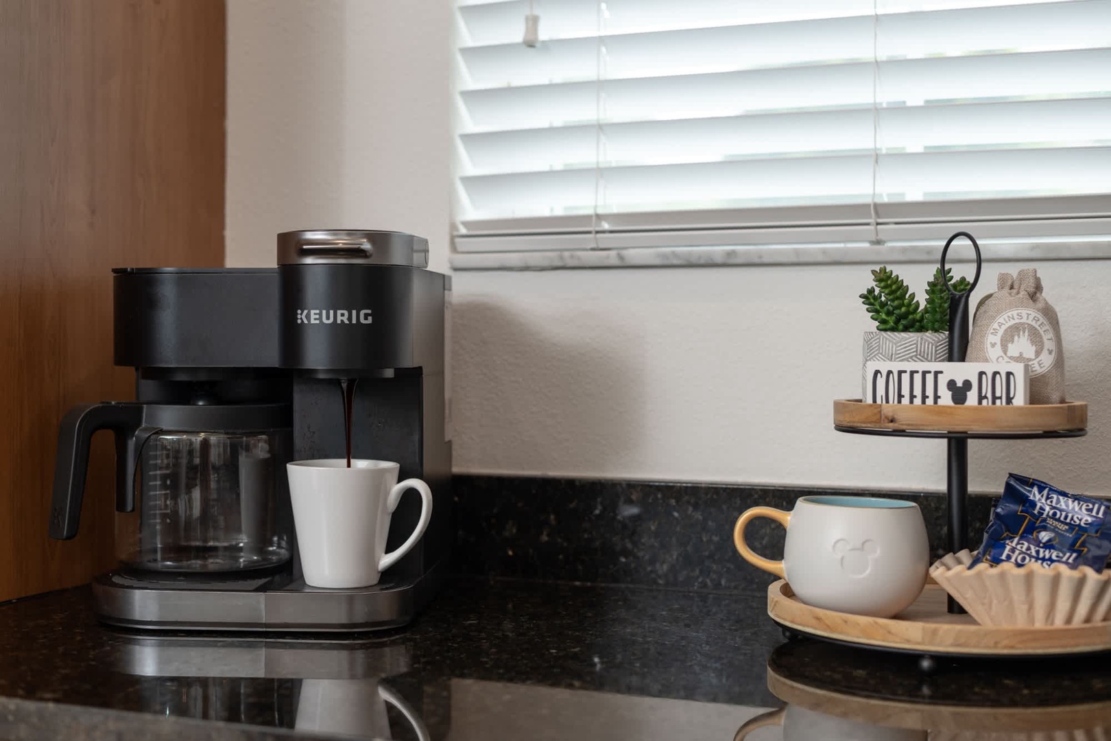Start your mornings right with a Keurig coffee maker ready at your fingertips—your perfect cup awaits on this sleek granite counter.