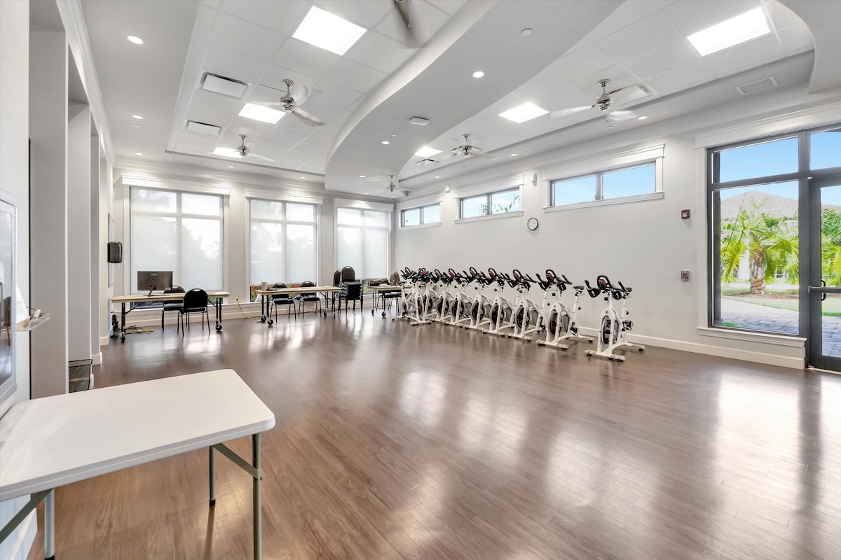 A bright, spacious fitness studio with a full fleet of spin bikes awaits your morning workout. Natural light floods the polished floors, creating an energizing space where you can keep up with your exercise routine.