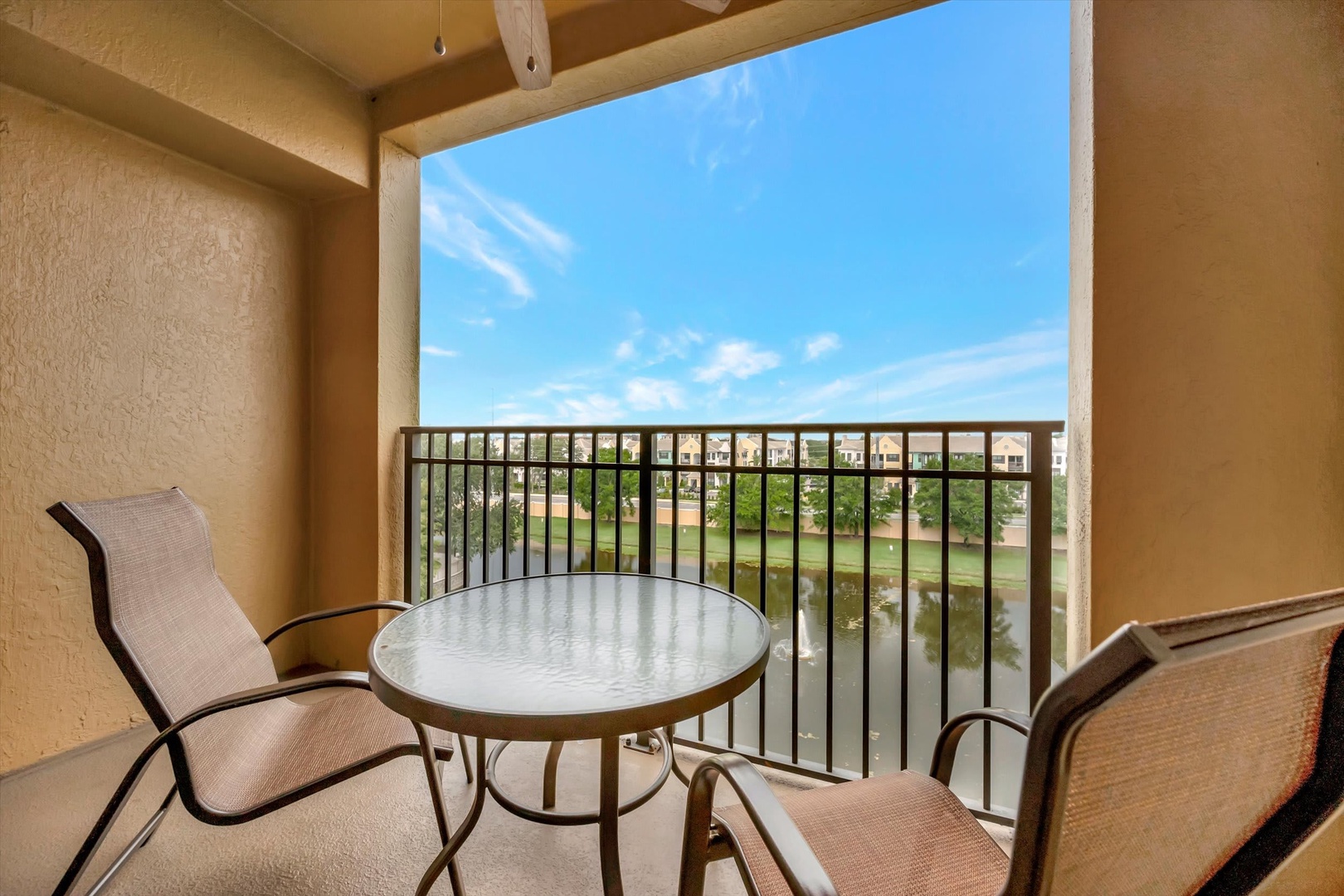 Step out onto your private balcony and breathe in the fresh air as you overlook peaceful water views. Relax at the small table with morning coffee or evening conversations, soaking in the sunshine and tranquil scenery.