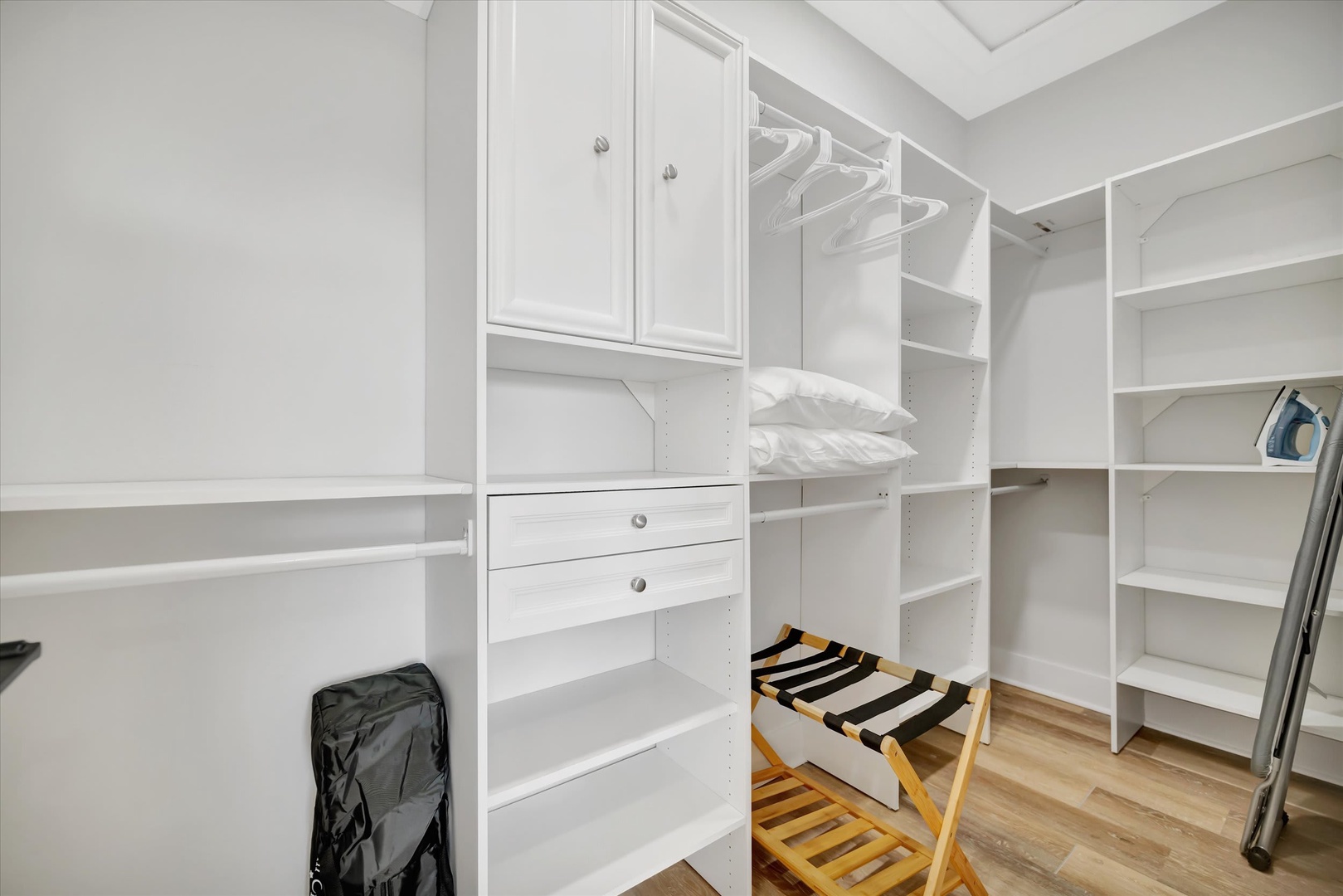 You'll find plenty of room for all your belongings in this spacious walk-in closet, designed with custom shelving, drawers, and hanging space to keep everything organized during your stay.