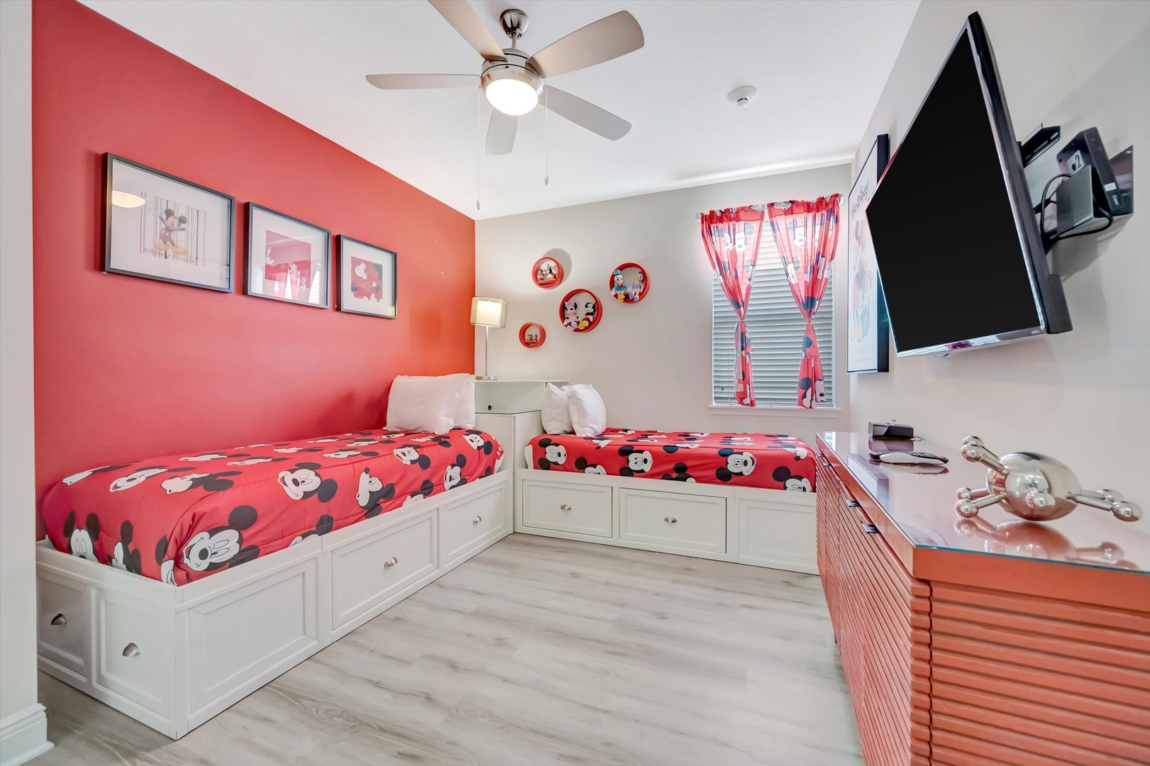 Your kids will love this cheerful bedroom with twin beds, playful decor, and their own wall-mounted TV—perfect for winding down after a fun-filled day.